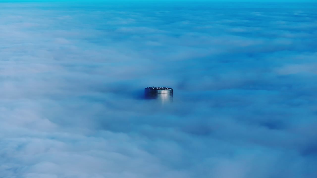 Cinematic orbit of Riga’s highest tower enveloped in morning fog from high sky