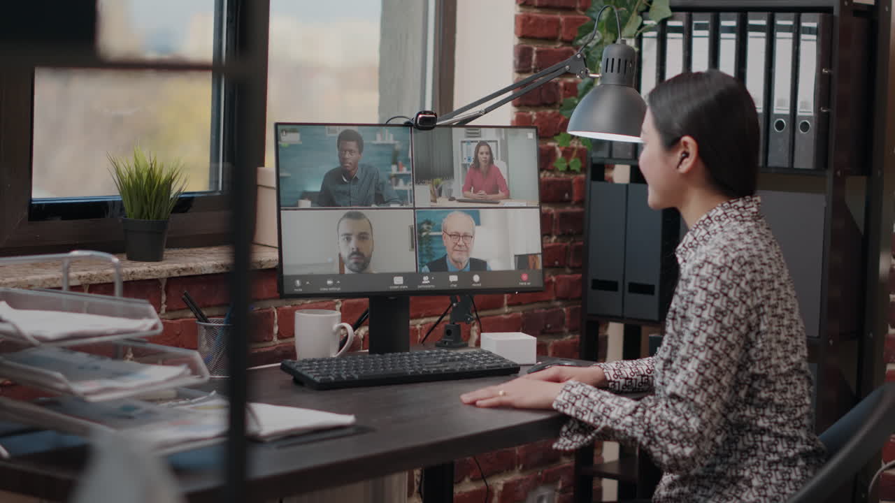 Asian woman attending business meeting on video call
