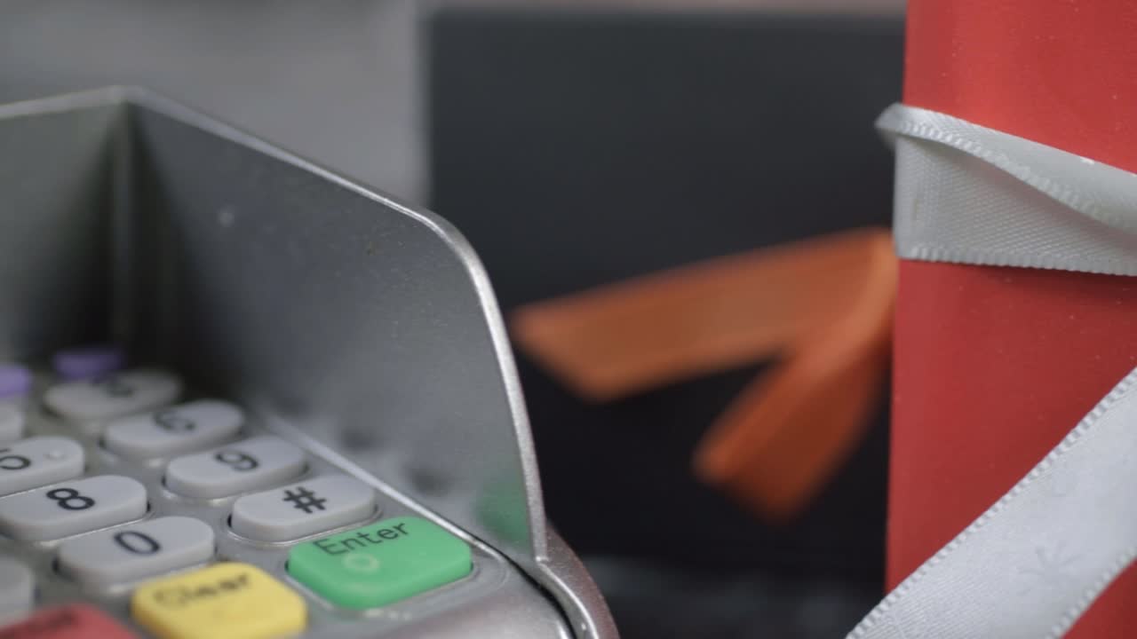 Pdq payment machine and wrapped gift panning close up panning shot