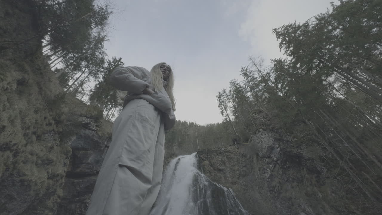 Woman in Front of Waterfall in Forest