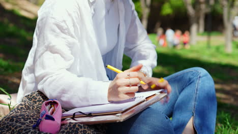 woman taking notes in a park