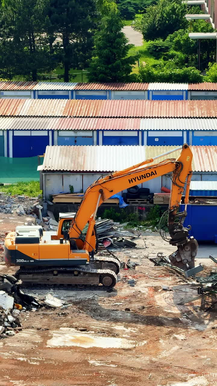 Excavator working in a construction site. Heavy machinery clears debris at a construction site, prepping for projects during daylight hours