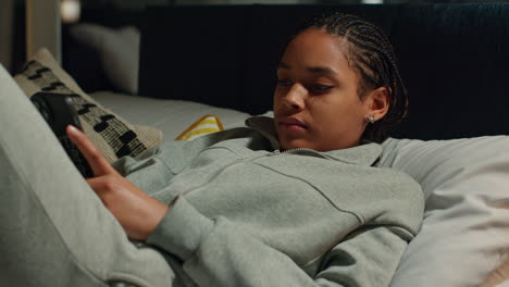 teenage girl using smartphone in bed