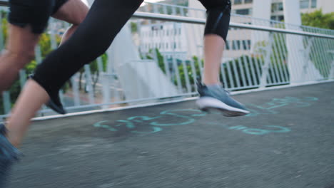 dos atletas en forma corriendo y corriendo en un puente