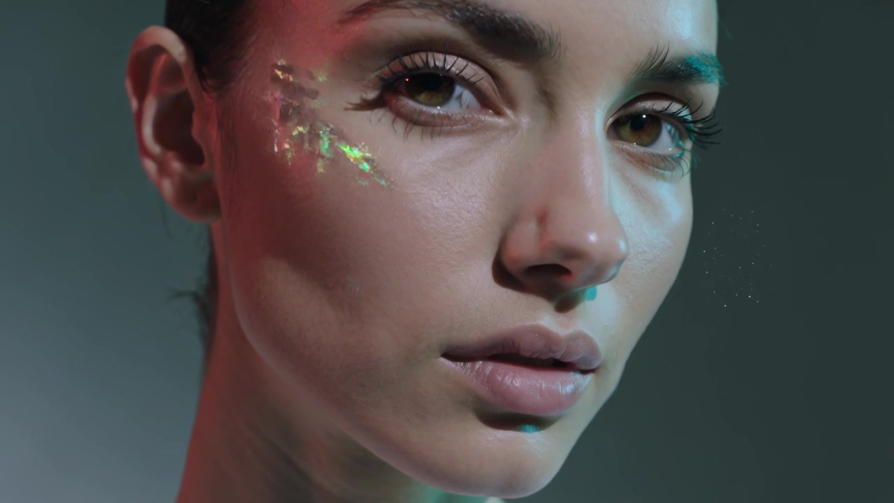 Rim lighting showing flakes, model posing while camera tightening to cheek in studio to show makeup