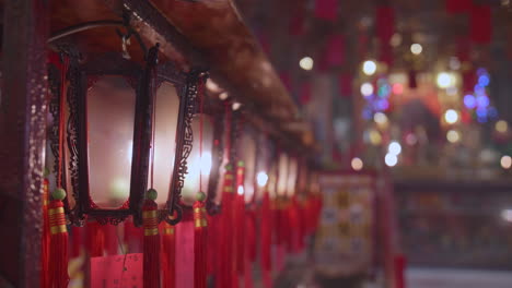 illuminated red lanterns hanging in a chinese temple