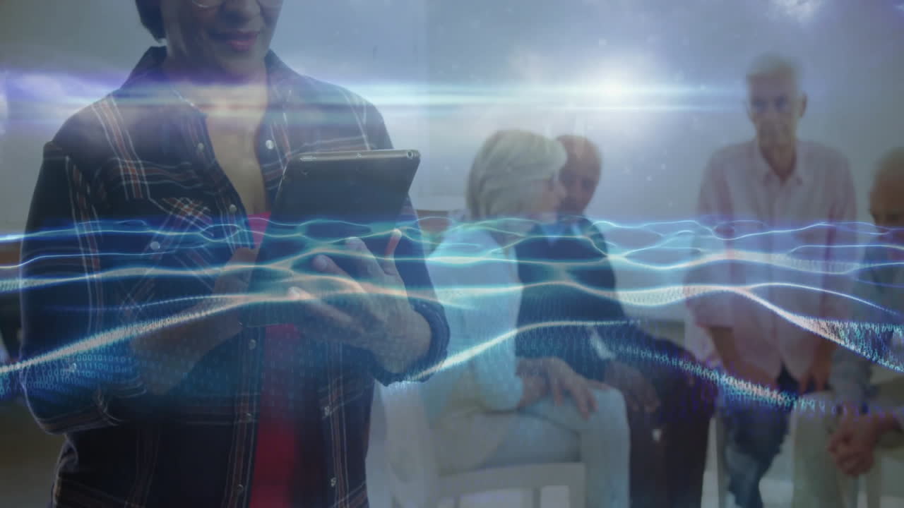 Group conducting technology workshop in bright meeting room, with tablet and digital wave overlay