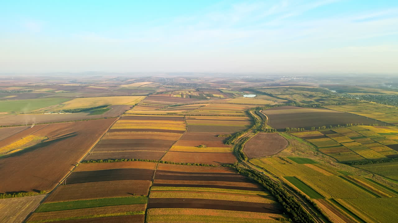 Aerial drone view of nature in Moldova at sunset. Wide fields, village, road