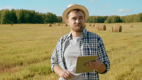 jovem agricultor usando computador tablet no campo