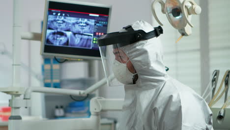 Portrait-of-dentist-with-protection-mask-speaking-with-patient