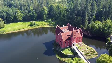 cervena lhota castle at the middle of the lake in south bohemian, czech republic. - aerial shot