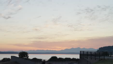 park sunset with mountain range and object silhouette