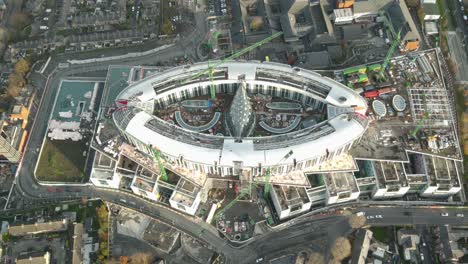 cars driving in the street of dublin city with new children's hospital under construction near the st james's hospital ireland