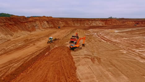 crawler excavator standing in sand quarry. aerial view of sand mining in quarry