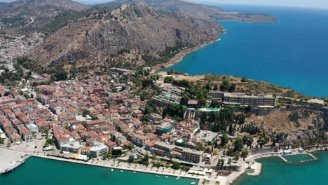 aerial view of coastal city of nafplio in the peloponnese peninsula in greece with fortress on hilltop in background