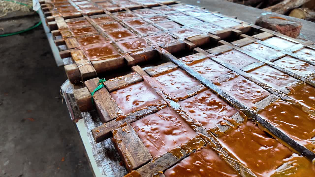 Caramelized sugarcane juice poured into molds to form rustic brown sugar blocks