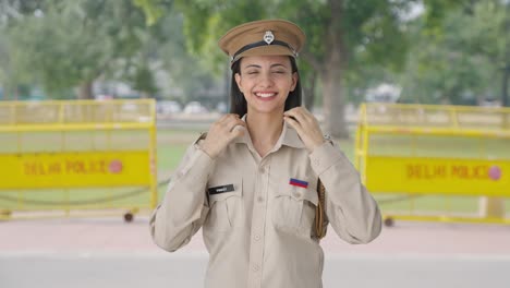 happy indian female police officer wearing hat