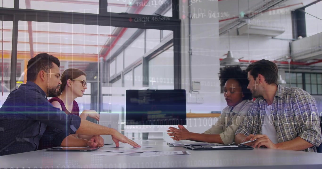 Biz team at table shifting from screen as woman pointing, spreading docs for review under d-overlay