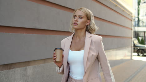 closeup woman walking at street. woman watching time on smart watch outdoor