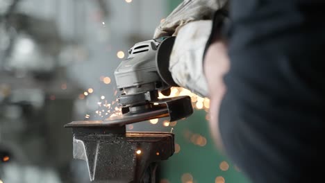 a man working with angle grinder, sparkles, super slow motion, close up