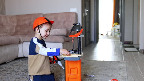 child plays with tools inside. a young boy dressed in a construction outfit uses a toy drill in a cozy indoor setting, fostering imaginative play