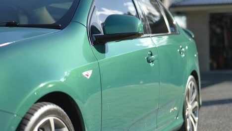 Side-Profile-of-Green-Sports-Sedan-In-Afternoon