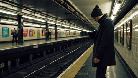 man waiting at subway station