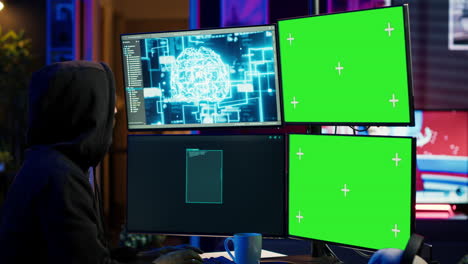 hacker using ai and green screen computer monitors to produce malicious malware