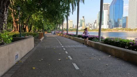 people walking and relaxing in a city park