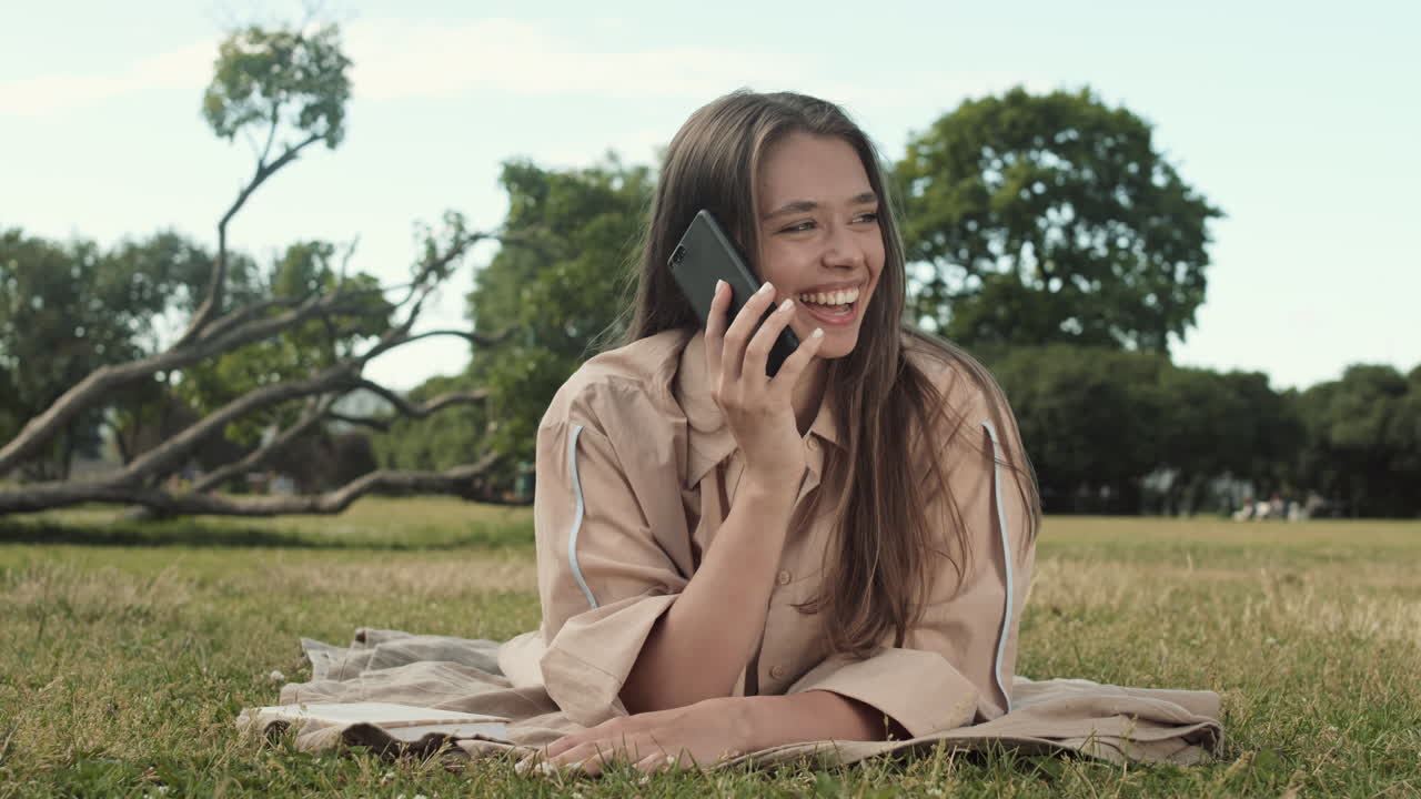 Woman Talking on Phone on Lawn