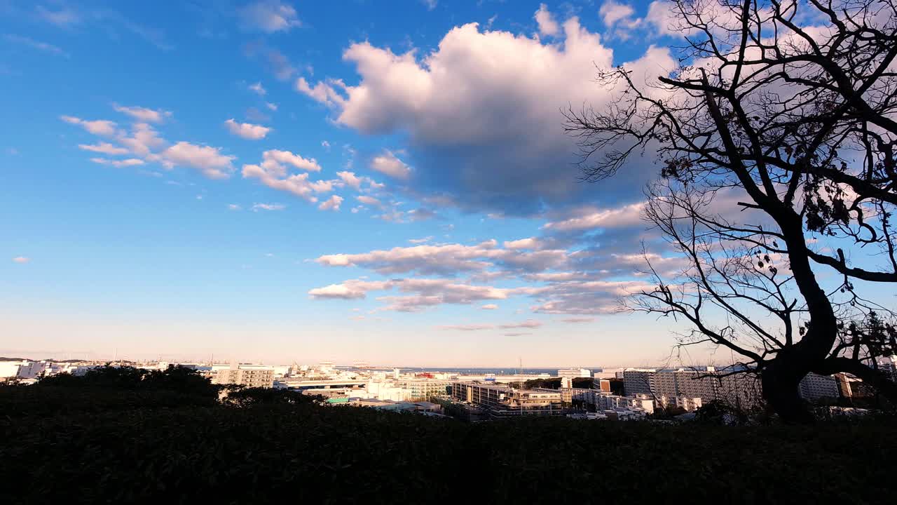 View over the city toward Yokohama Bay from the park in Tomioka city in the evening. Beautiful day with clouds.