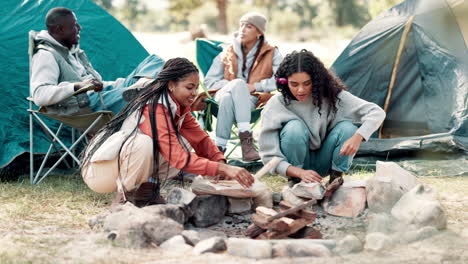 friends camping and making a campfire