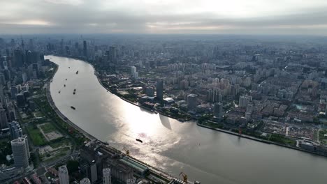 drone aerial view of buildings, cityscape and river in downtown