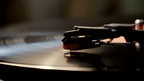 close-up of using an antiquarian vinyl record player. turntable player,dropping stylus needle on vinyl record playing