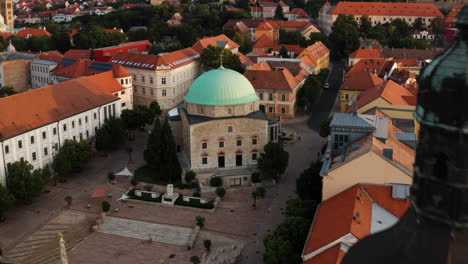 famous mosque of pasha qasim victorious on szechenyi square, pecs, hungary - aerial drone shot