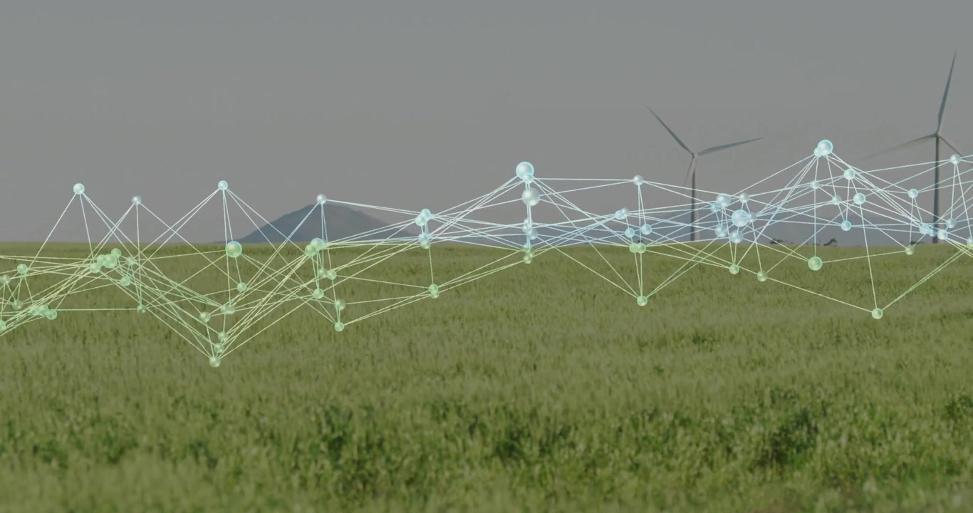 Nodi e linee traslucidi e luminosi che fluttuano su un campo verde, rendering 3D che mostra una turbina eolica