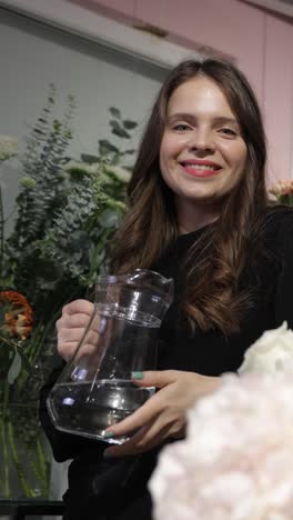 a Cheerful Florist Holding a Water Pitcher Surrounded by Beautiful and Stunning Floral Arrangements a Cheerful Florist Holding a Water Pitcher Surrounded by Beautiful and Stunning Floral Arrangements