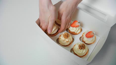 delicious strawberry and walnut cupcakes in a white box