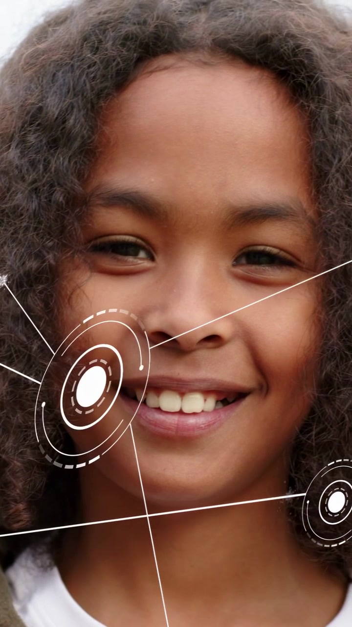 Vertical video: Boy smiling while ring UI appearing left moving across face for tech smile tracking