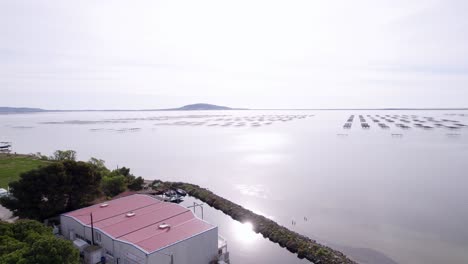 Aerial-video-sequence-of-seafood-oyster-farms-near-Sète-city,-south-of-France