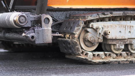 tracked paver machine during asphalt pavement works for road repairing in berlin