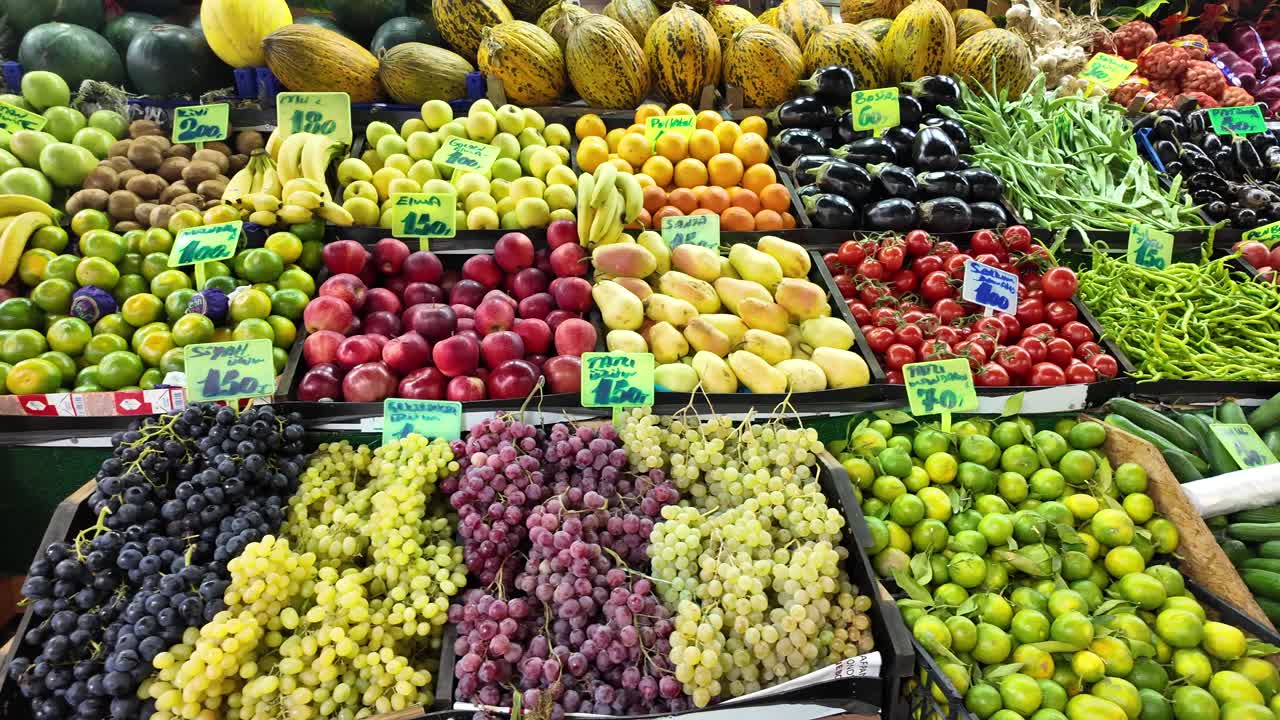 A colorful fruit stand with a variety of fresh produce