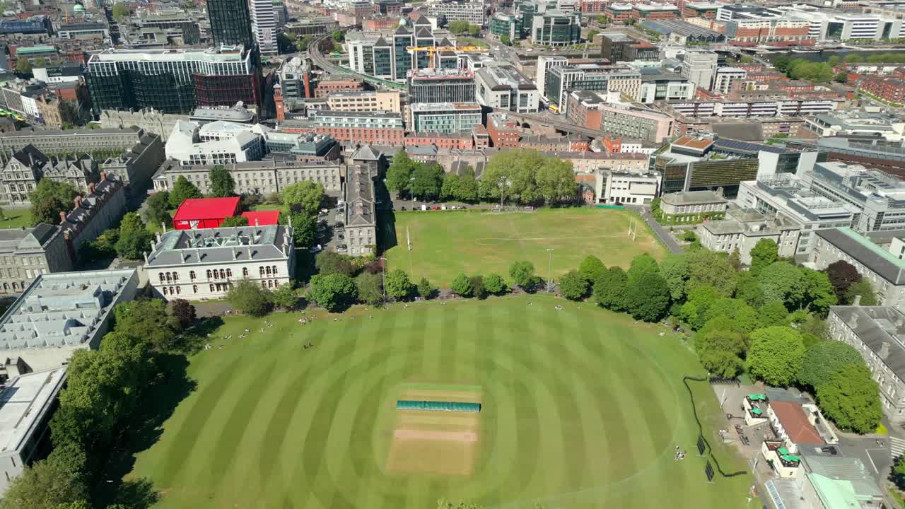 Wide reversing aerial video of the campus and surrounding areas of Trinity College in Dublin, Ireland on a sunny day. Filmed in 4K, 60FPS and with Rec709 color.
