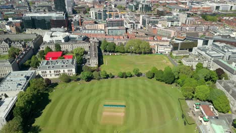 wide reversing aerial video of the campus and surrounding areas of trinity college in dublin, ireland on a sunny day. filmed in 4k, 60fps and with rec709 color.