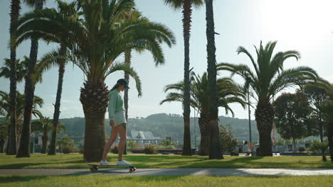 woman skateboarding in a park with palm trees