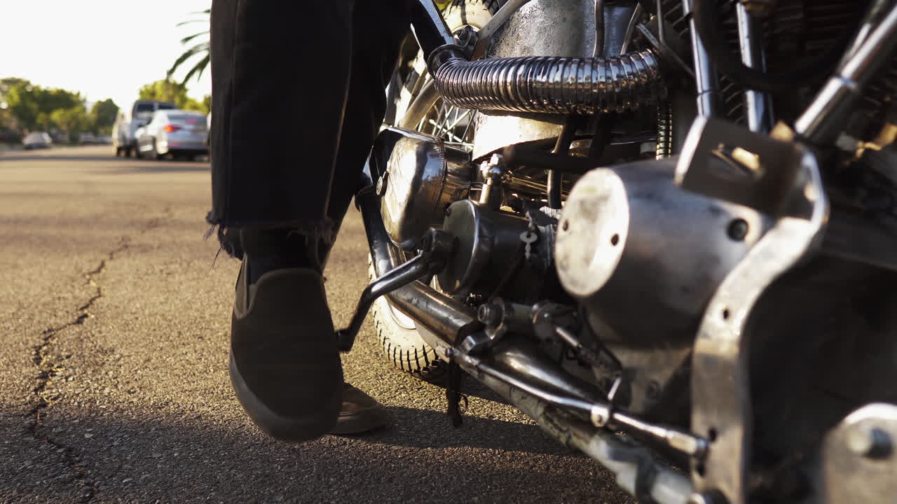 Struggling to kick start a motorcycle on the roads of California