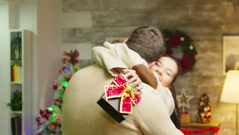 young woman gives husband a big hug