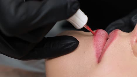 a professional master performs lip correction procedures a professional master performs lip correction procedures pencil for permanent makeup during work lip microblading doctor cosmetologist