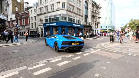 blue supercar navigates crowded city intersection