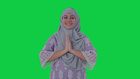 happy muslim woman doing namaste green screen